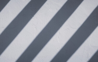 slanted shadow stripes on white wall