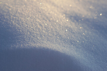 cold snow surface with sun light and wave - winter close up, frozen shining background