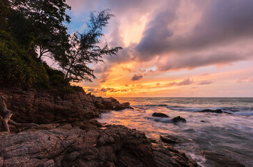 Fototapeta na wymiar Tropical sunset at stones beach