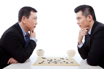 Two business men playing chess