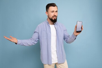 Photo of thoughtful handsome good looking young brunette unshaven man with beard wearing casual...