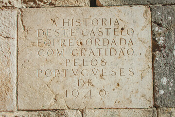 memorable stone plate on the stone wall of the castle