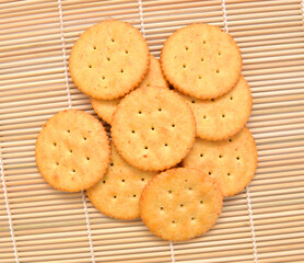 Delicious crackers isolated on bamboo mat
