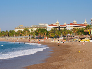Alanya, Turkey - 11.15.2020. Beach day, blue sea and green trees and palms. Copy space for text.