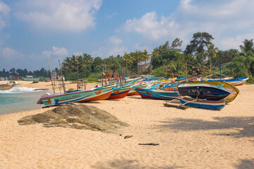 Fishing boats on a sandy beach on the Indian Ocean on a sunny day
