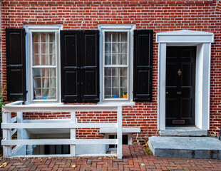 Elfreth's Alley a historic street from colonial era in Old City, Philadelphia. House with black door and black window's shutters. National Historic Landmark.