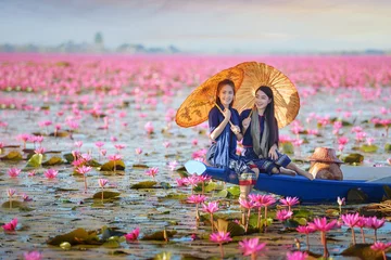 Fotobehang Lotusbloem Asian woman wearing traditional thai culture,vintage style,Lake of pink lotus,Thailand  © saravut
