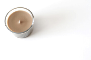 brown candle on white background top view
