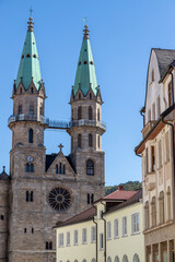 Fototapeta na wymiar Street with house facades and view to the town church in Meiningen