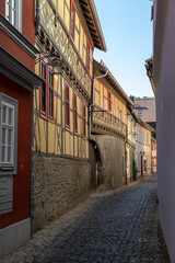Fototapeta na wymiar Narrow cobbled alley with facades of half-timbered houses in Meiningen
