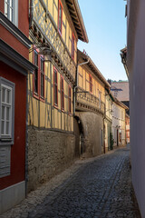 Fototapeta premium Narrow cobbled alley with facades of half-timbered houses in Meiningen