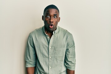 Obraz premium Young african american man wearing casual clothes afraid and shocked with surprise expression, fear and excited face.