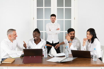 Group of business workers smiling happy and confident. Posing together with smile, young handsome man with crossed arms at the office