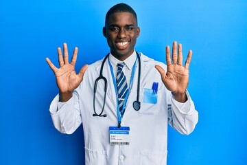 Young african american man wearing doctor uniform showing and pointing up with fingers number ten while smiling confident and happy.