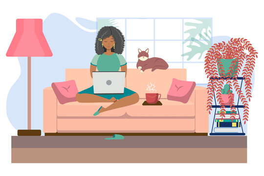 Young black woman working or studying from home, sitting on the couch, in a cozy atmosphere, with tea and a cat. Concept of covid-19 quarantine, freelancing, work and learning from home.