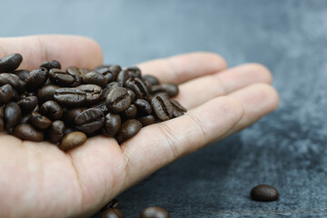 Medium roasted coffee beans in hand