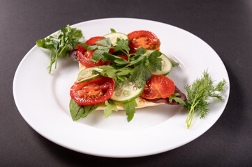 Vegetables and herbs on a plate. Serving vegetables in a plate.