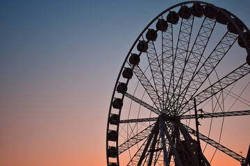Rotterdam, Netherlands-April 19, 2019: Ferris Wheel Over Blue and orange Sky Background..