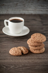 a cup of coffee with oatmeal cookies