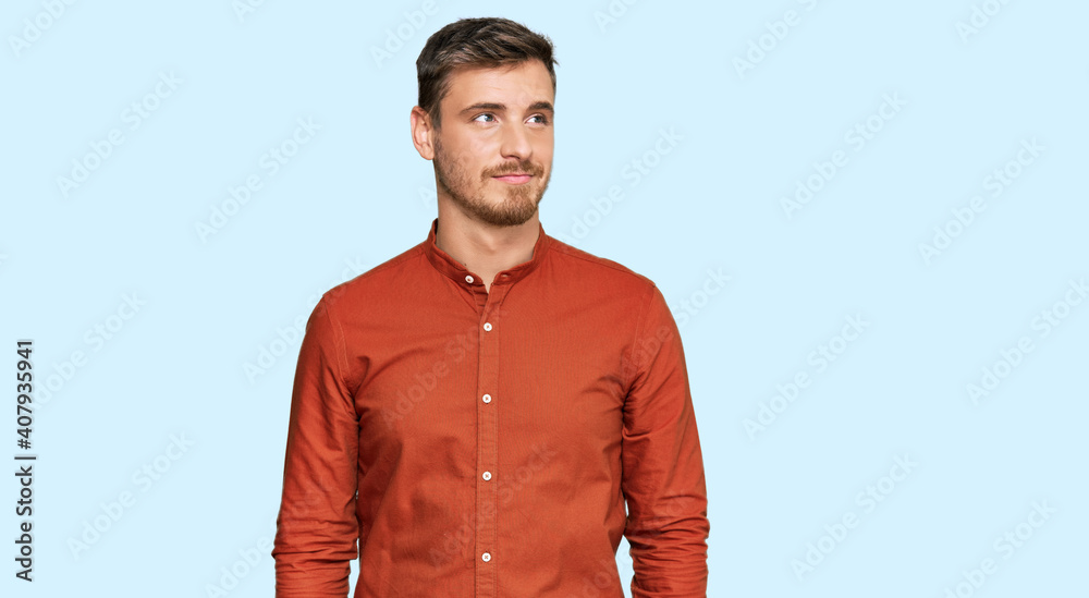 Wall mural handsome caucasian man wearing casual clothes smiling looking to the side and staring away thinking.