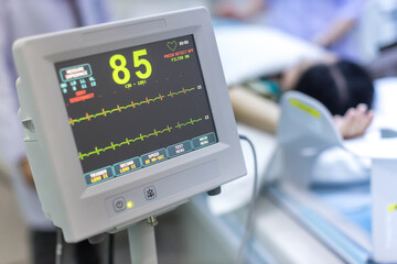 Electrocardiogram in hospital CT Scan room. heart rate monitor in hospital. Process of CT scanning of an old patient. Man Receiving a Medical Scan for a Trauma