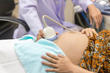 Pregnant woman getting ultrasound from doctor.