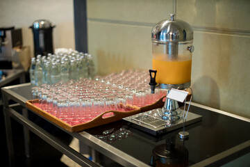 Orange juice in water cooler for breakfast at the hotel. Fresh orange juice from tank in buffet line. 