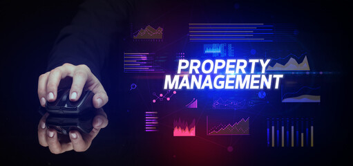 hand holding wireless peripheral with PROPERTY MANAGEMENT inscription, cyber business concept