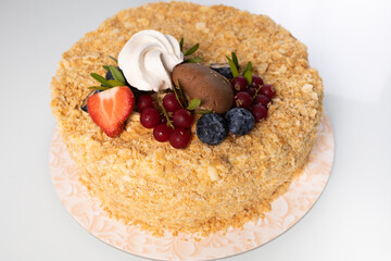 Napoleon cake with berries close-up on a case table