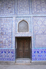 Khiva, Uzbekistan - December 02 2019: Ancient wall and door with ornament. Interior decoration of the Tosh-Hovli palace