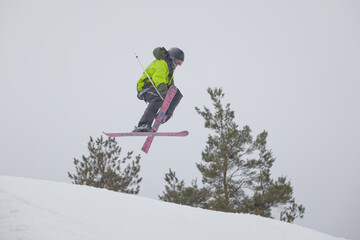 Snowboarder jumping high through the air at the Wisp Ski Resort in Deep Creek Lake Maryland