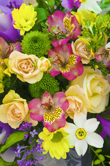 Natural flower bouquet. Pink alstroemeria, beige roses and yellow chrysanthemums flowers. Vertical.