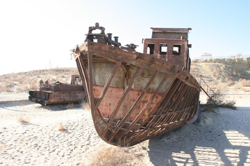 Moynaq (Mo‘ynoq or Muynak), Uzbekistan - Desember 06 2019:  an abandoned rusty ship in the Aral...
