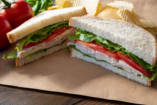 Turkey, Lettuce And Tomato Sandwich On Brown Paper