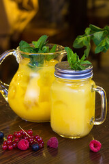 Refreshing orange lemonade in decanters to serve in a restaurant. Still life.