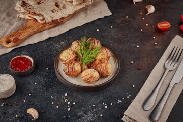 Grilled potatoes, textured dark background