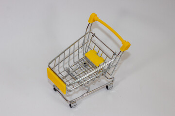 Yellow toy cart on white isolated background