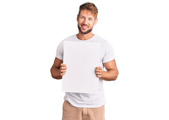 Young caucasian man holding blank empty banner looking positive and happy standing and smiling with...