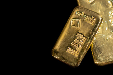 Valcambi Suisse gold bullion bar on black background. Large cast investment gold ingot. Swiss gold....