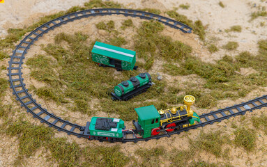 Toy Model railway on the Ground surrounded by grass