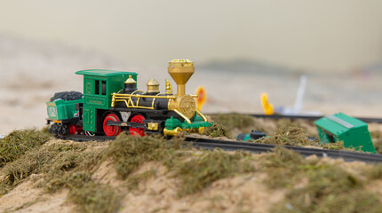 Toy Model railway on the Ground surrounded by grass