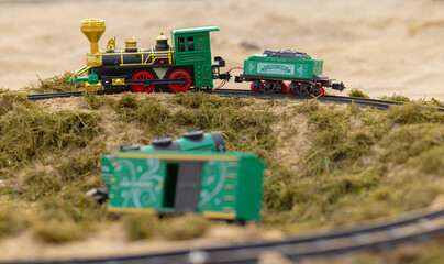 Toy Model railway on the Ground surrounded by grass