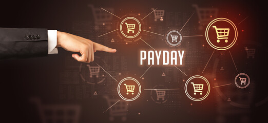 Close-Up of cropped hand pointing at PAYDAY inscription, online shopping concept