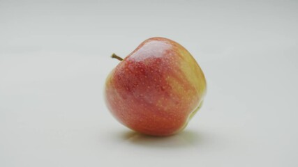 Apples hit, two organic natural wet moving fruits strike collide with each other, close up studio video