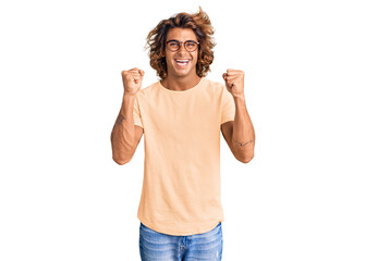 Young hispanic man wearing casual clothes and glasses celebrating surprised and amazed for success...