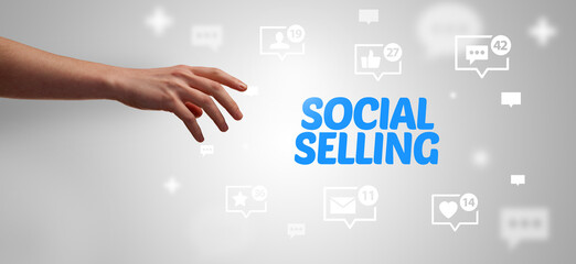 Fototapeta premium Close-Up of cropped hand pointing at SOCIAL SELLING inscription, social networking concept