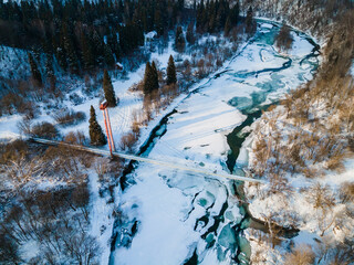 Suspension Bridge in Dwerniczek, Bieszczady Mountains Park in Poland. Frozen San River. Drone View in Winter