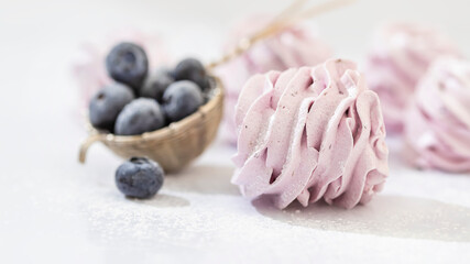 Handmade marshmallow with blueberries, white background. Violet Marshmallow, Meringue, Zephyr.
