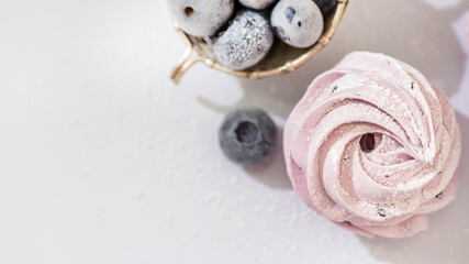 Handmade marshmallow with blueberries, white background. Violet Marshmallow, Meringue, Zephyr.