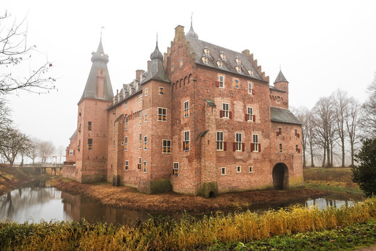 Medieval Doorwerth Castle   on the river Rhine near the city of Arnhem on a foggy winter day, Netherlands.